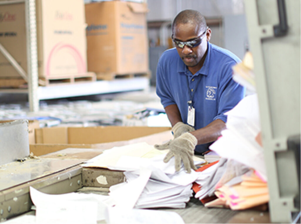 Secured Document Shredding employee preparing documents for shredding