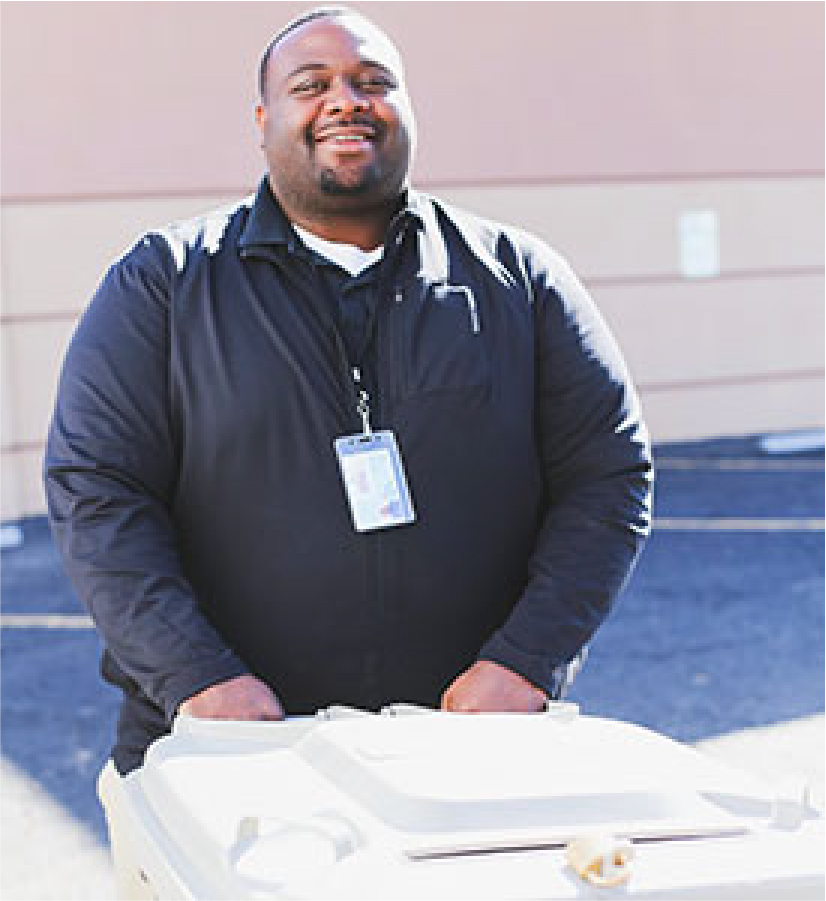 Secured Document Shredding shred truck employee moving shred bin