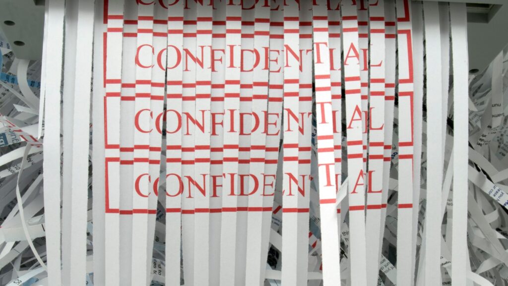 shredded paper with the word confidential on it