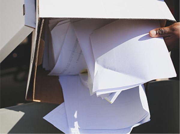 Asset-33@3x-100-2.jpg Box of documents being emptied