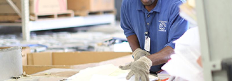 Asset-34@3x-100-2.jpg Secured Document Shredding employee preparing documents for shredding
